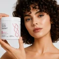 Woman holding Herbalife Skin Collagen Beauty Booster supplement for healthier-looking skin