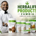 Coach Foster in premium activewear with Herbalife products available in Zambia, including Formula 1 Healthy Meal Shake, Protein Drink Mix, Tri-Blend Select Protein Shake and Protein Chips.