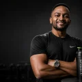 Herbalife Zambia Prices 2026 featuring Coach Foster with Herbalife shaker in a premium fitness studio